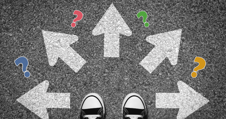 looking down at pavement with white arrows pointing in different directions and questions marks